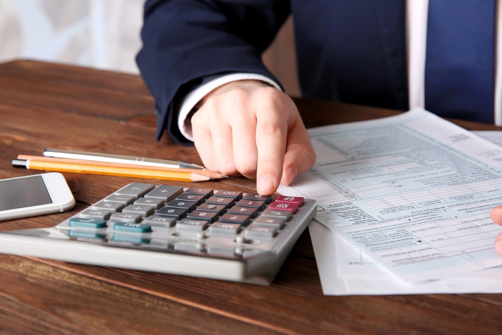Man filing a business personal property return in his office 