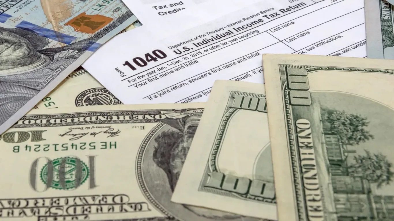 dollar bills and IRS Form 1040
