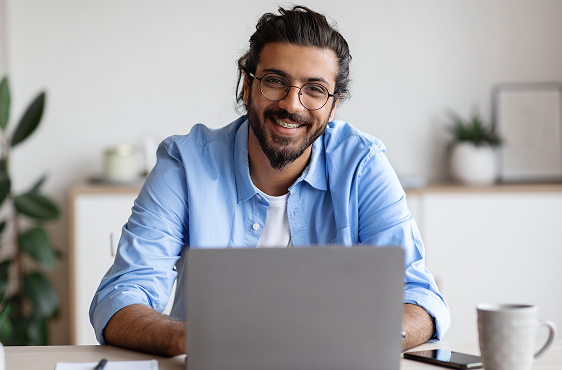 happy-indian-freelancer-man-sitting-at-desk