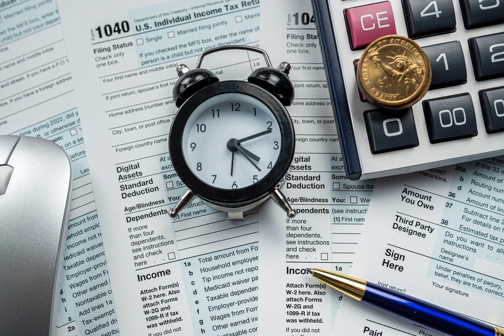 1040 tax form with clock to illustrate timeline for paying property taxes