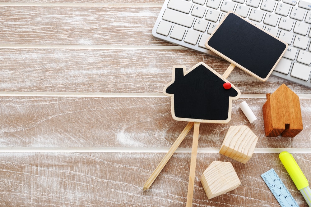 mini home chalkboard resting on keyboard to illustrate SALT deduction cap symbolism