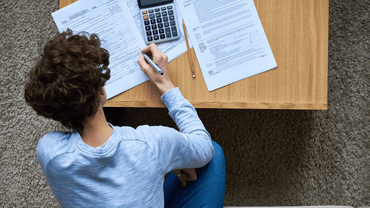 person sitting down doing their taxes
