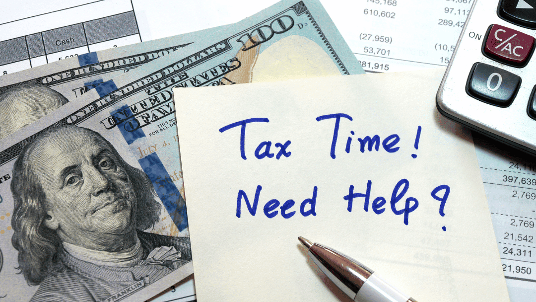 Money, calculator and sticky with tax time need help written on sticky note