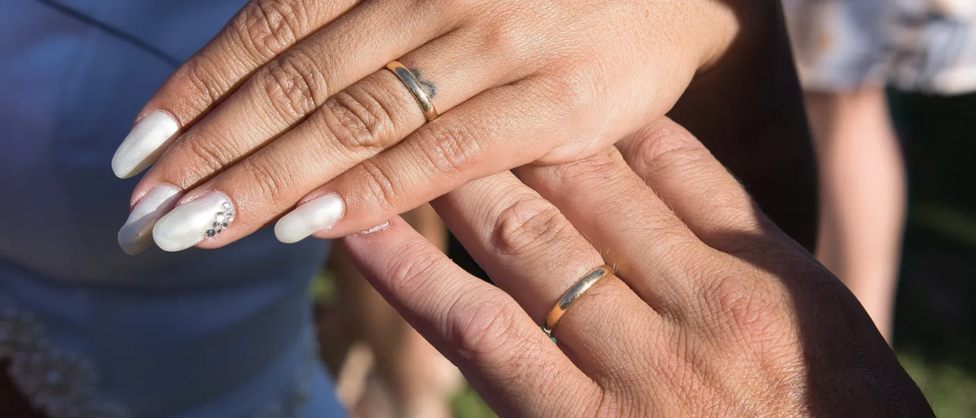 newlywed couple showing their rings