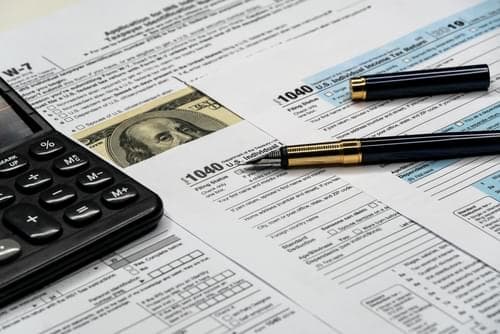 Image of pen and calculator over Form 1040