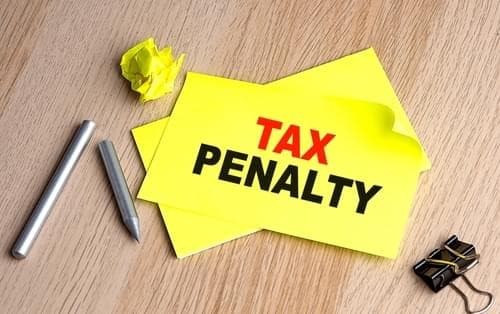 Yellow paper with tax penalty written on it